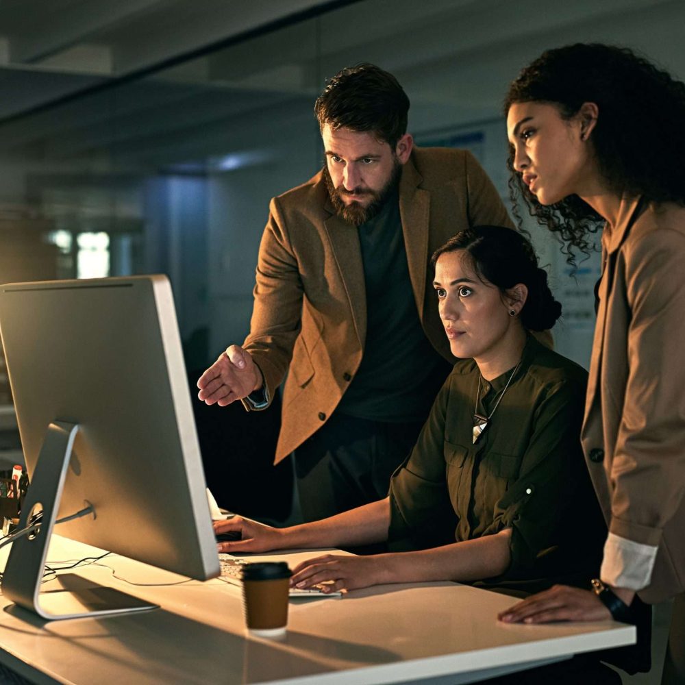 Putting in the extra time to achieve success. Cropped shot of colleagues working late